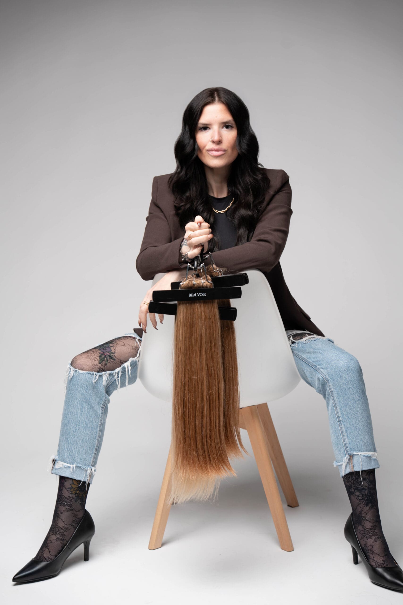 Hair artist holding hand-tied extension wefts